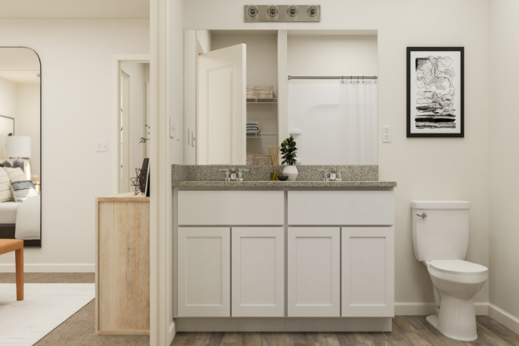 A bathroom with white cabinets.