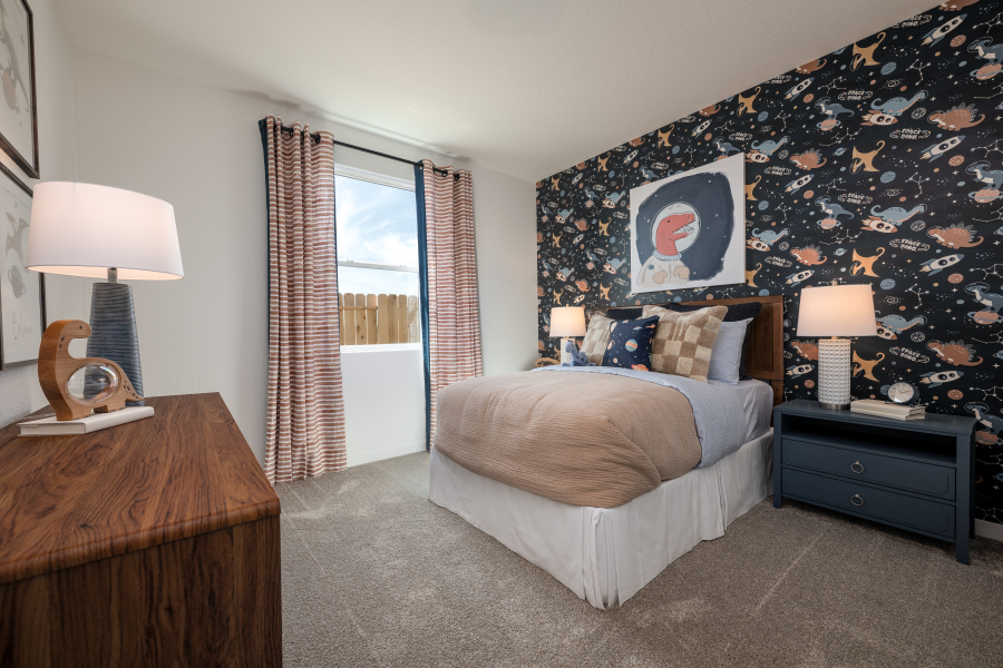 A bedroom with a bed and lamps.