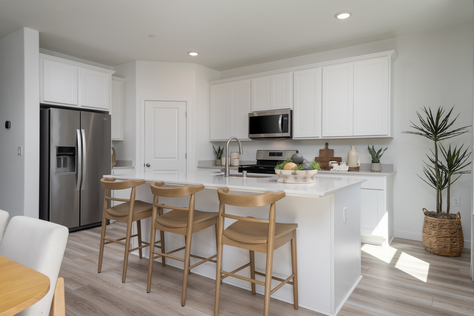 A kitchen with white cabinets.