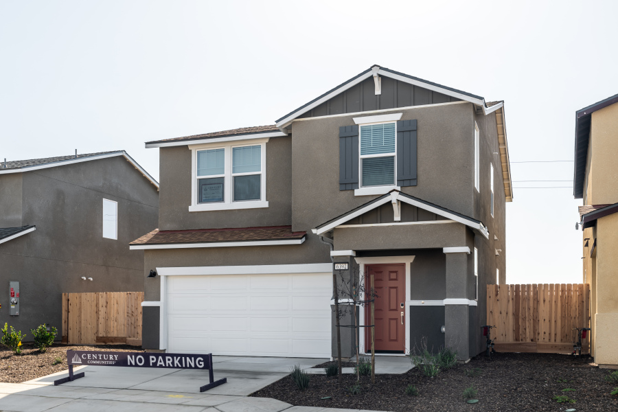 A house with garages and a fence.