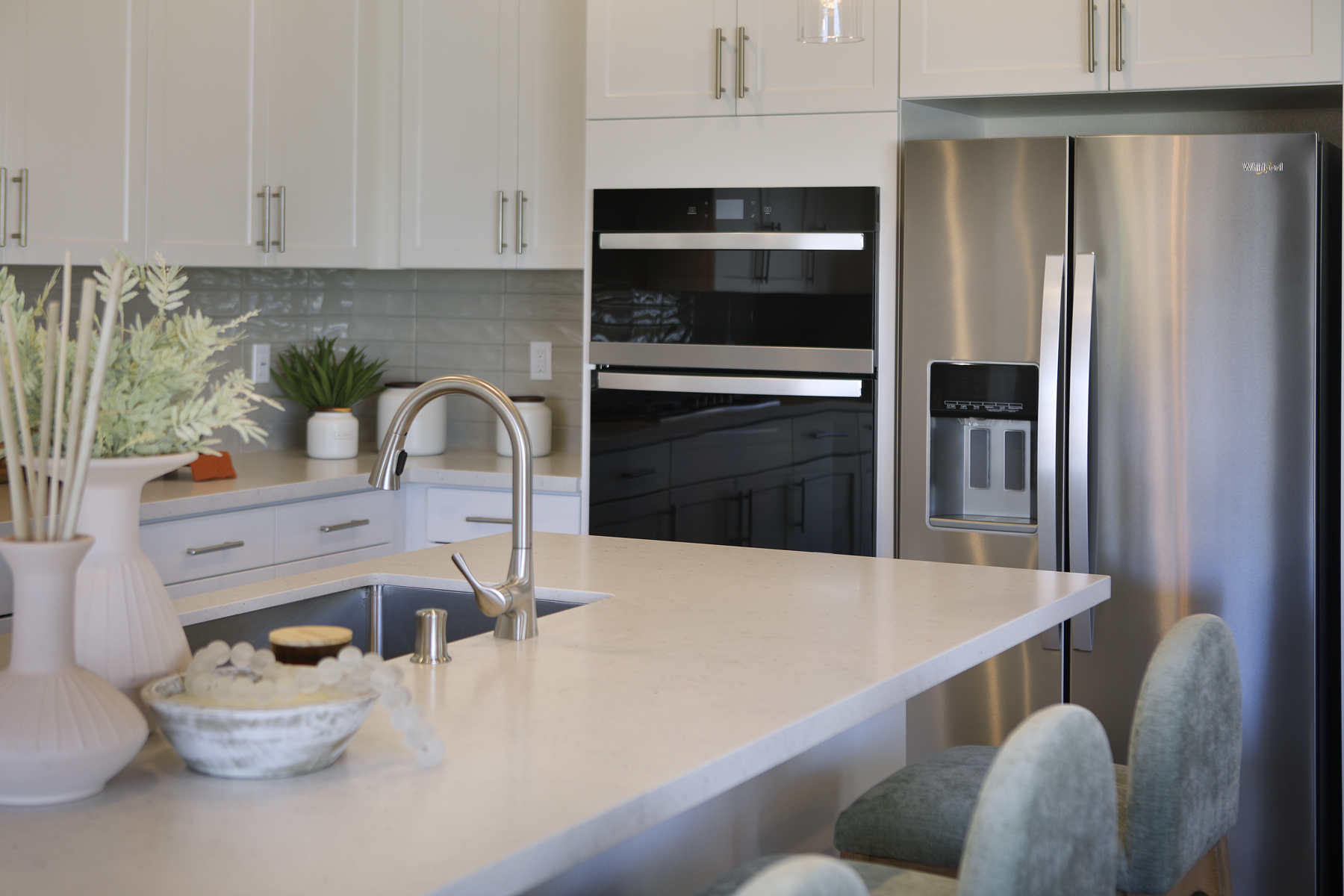 A kitchen with white cabinets.
