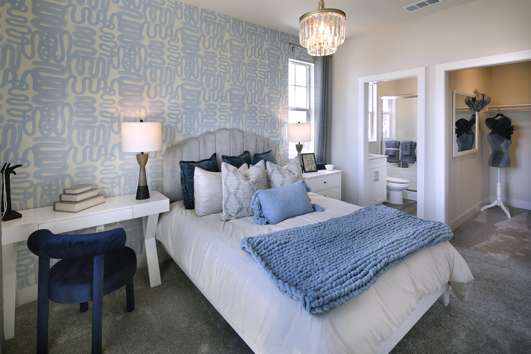 A bedroom with a bed and a table.