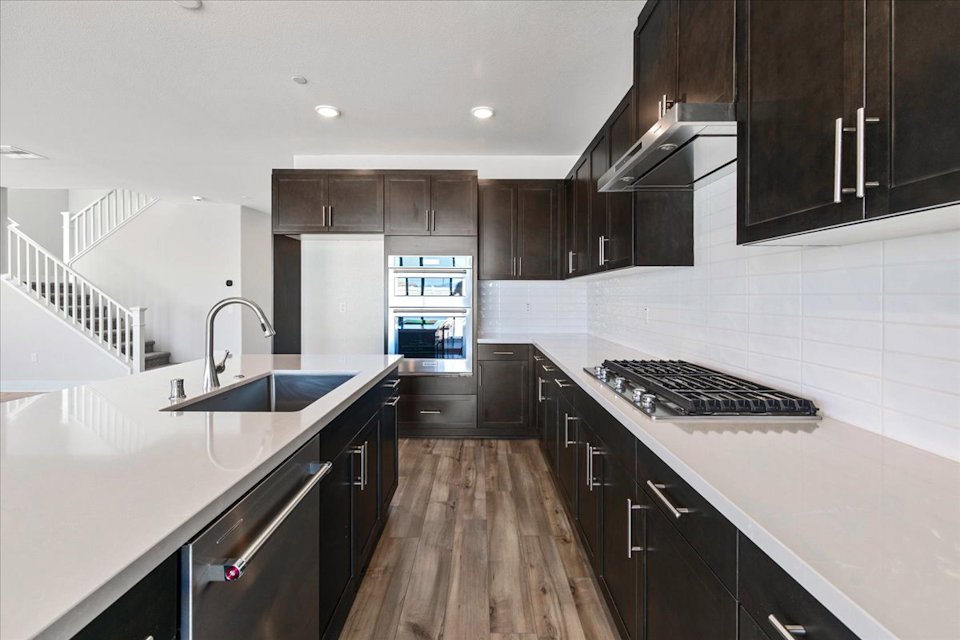 A kitchen with black cabinets.
