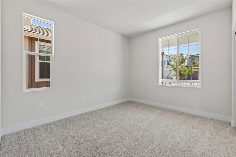 A room with a window and a plant in it.