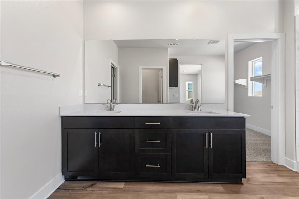 A bathroom with black cabinets.