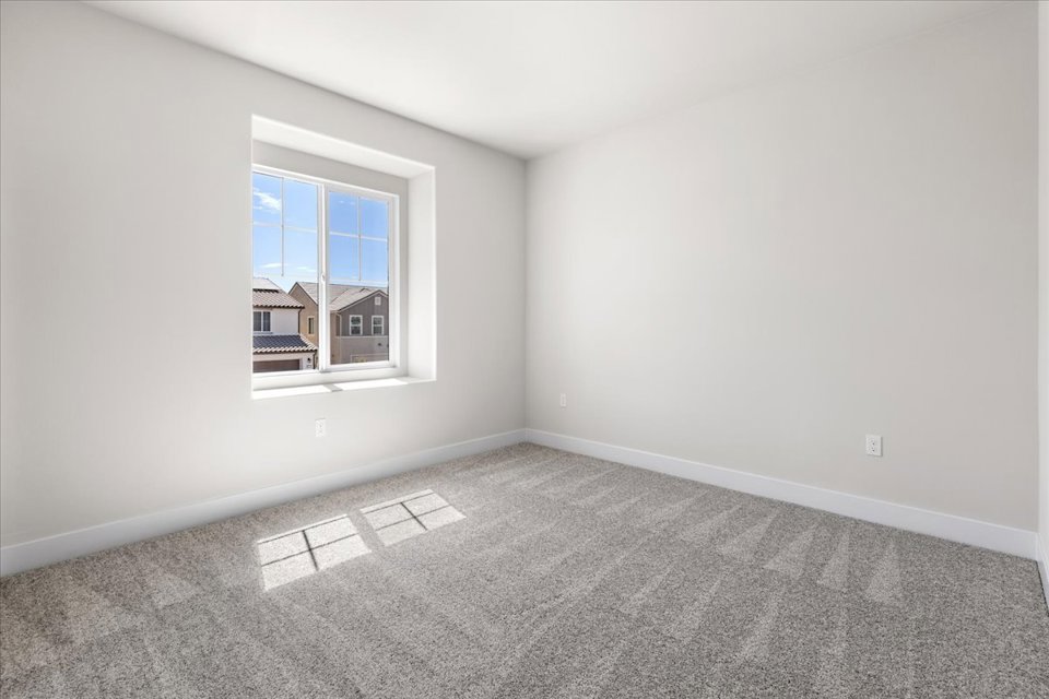 A room with a window and a carpet.