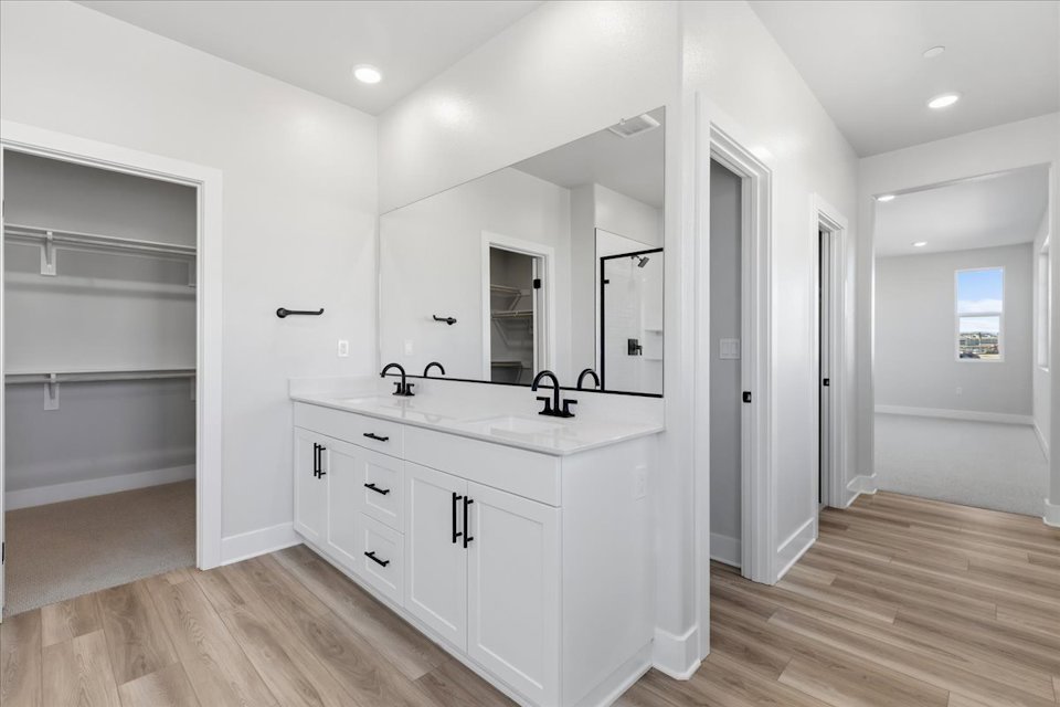 A bathroom with white cabinets.