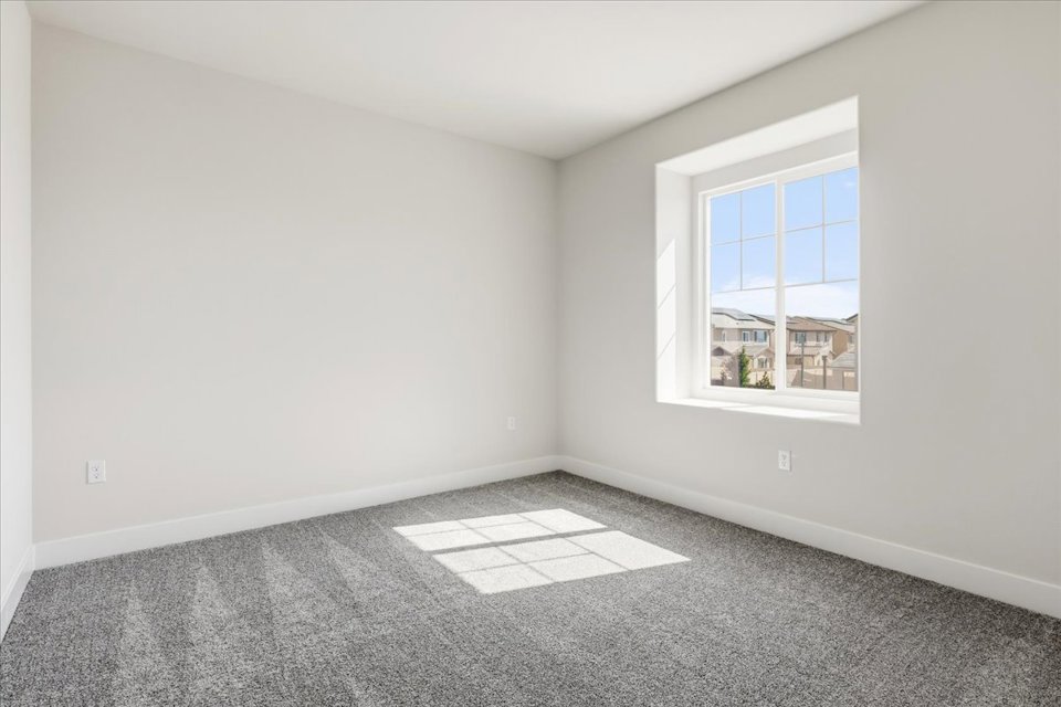 A room with a window and a tile floor.