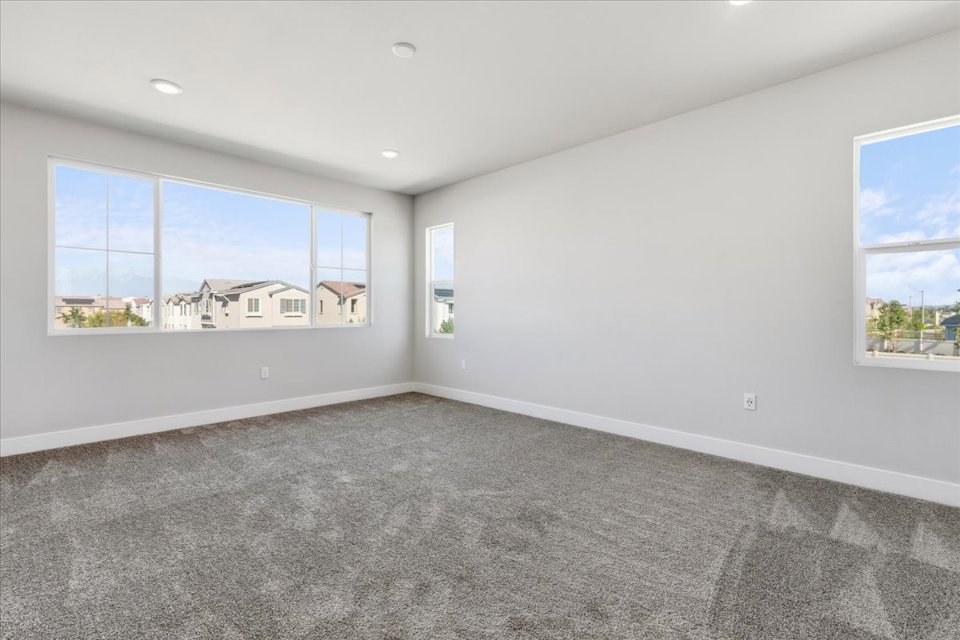 A room with a large window and a carpet.