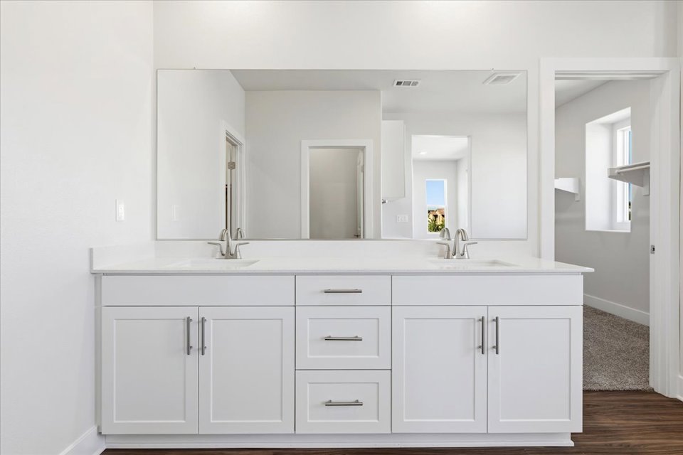 A white kitchen with white cabinets.