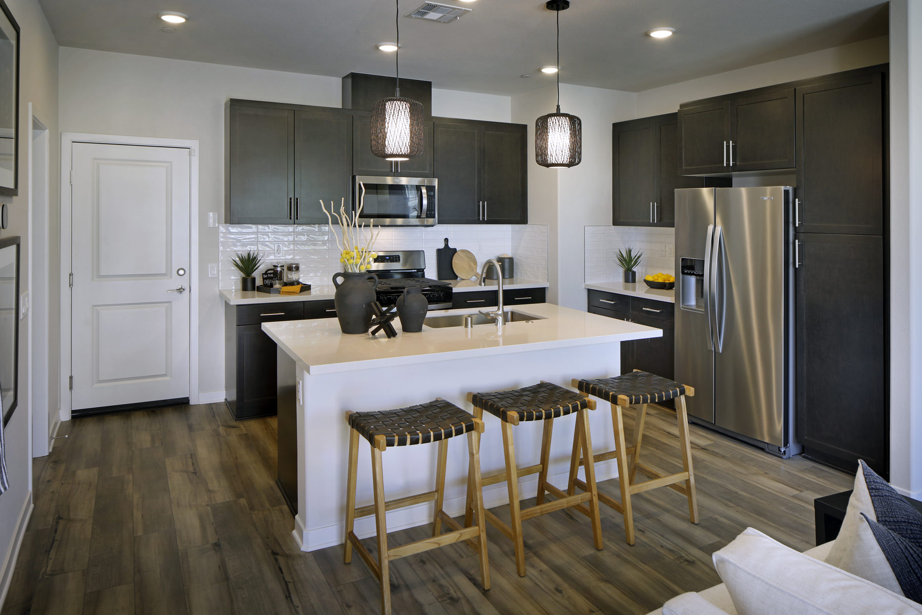 A kitchen with a bar and stools.