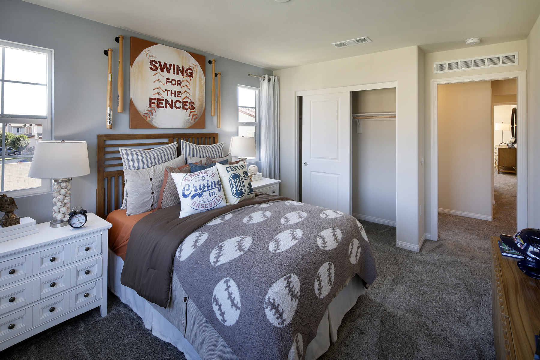 A bedroom with a bed and a dresser.