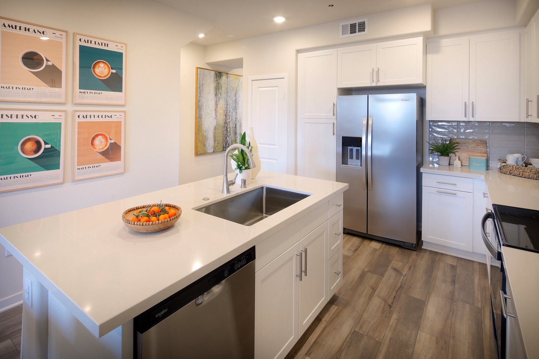 A kitchen with white cabinets.