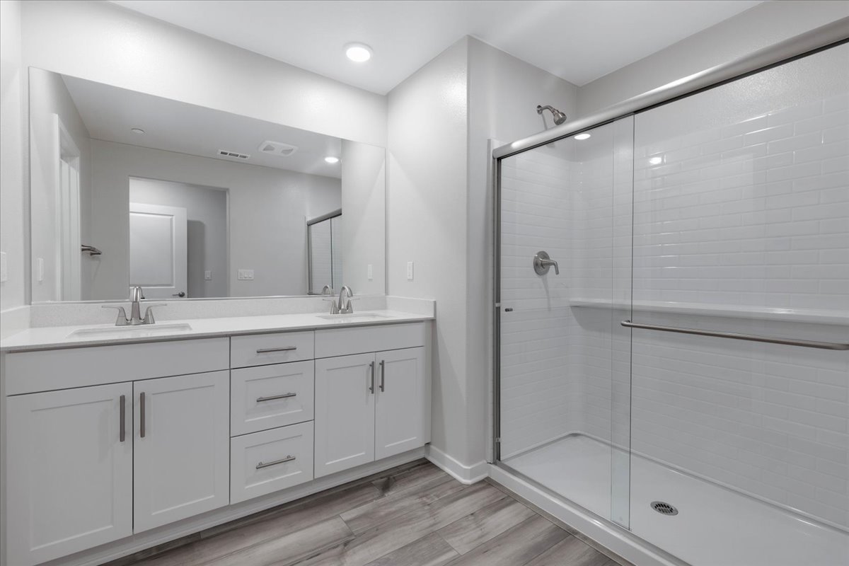 A bathroom with white cabinets.