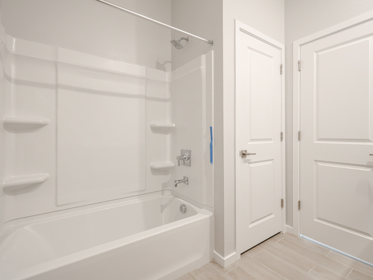A bathroom with a tub sink and toilet.