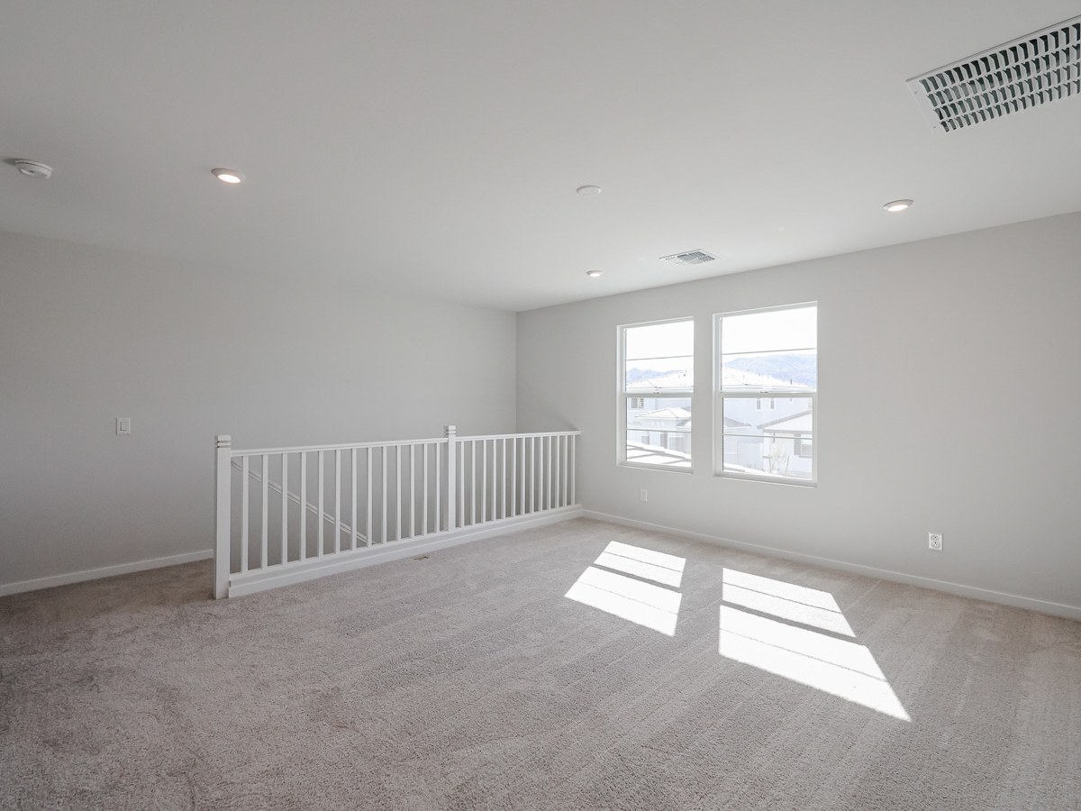 A room with a white railing and a white railing.