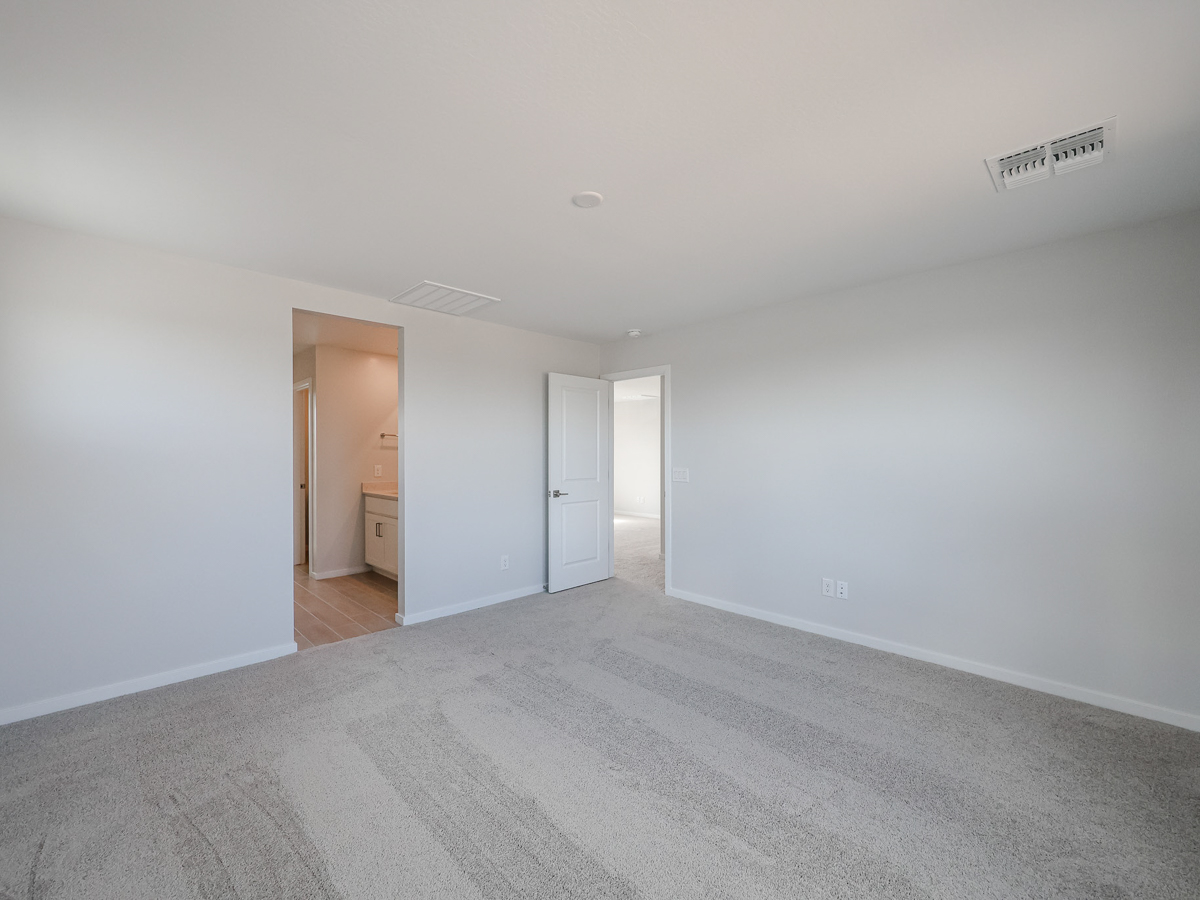 A long hallway with white doors.