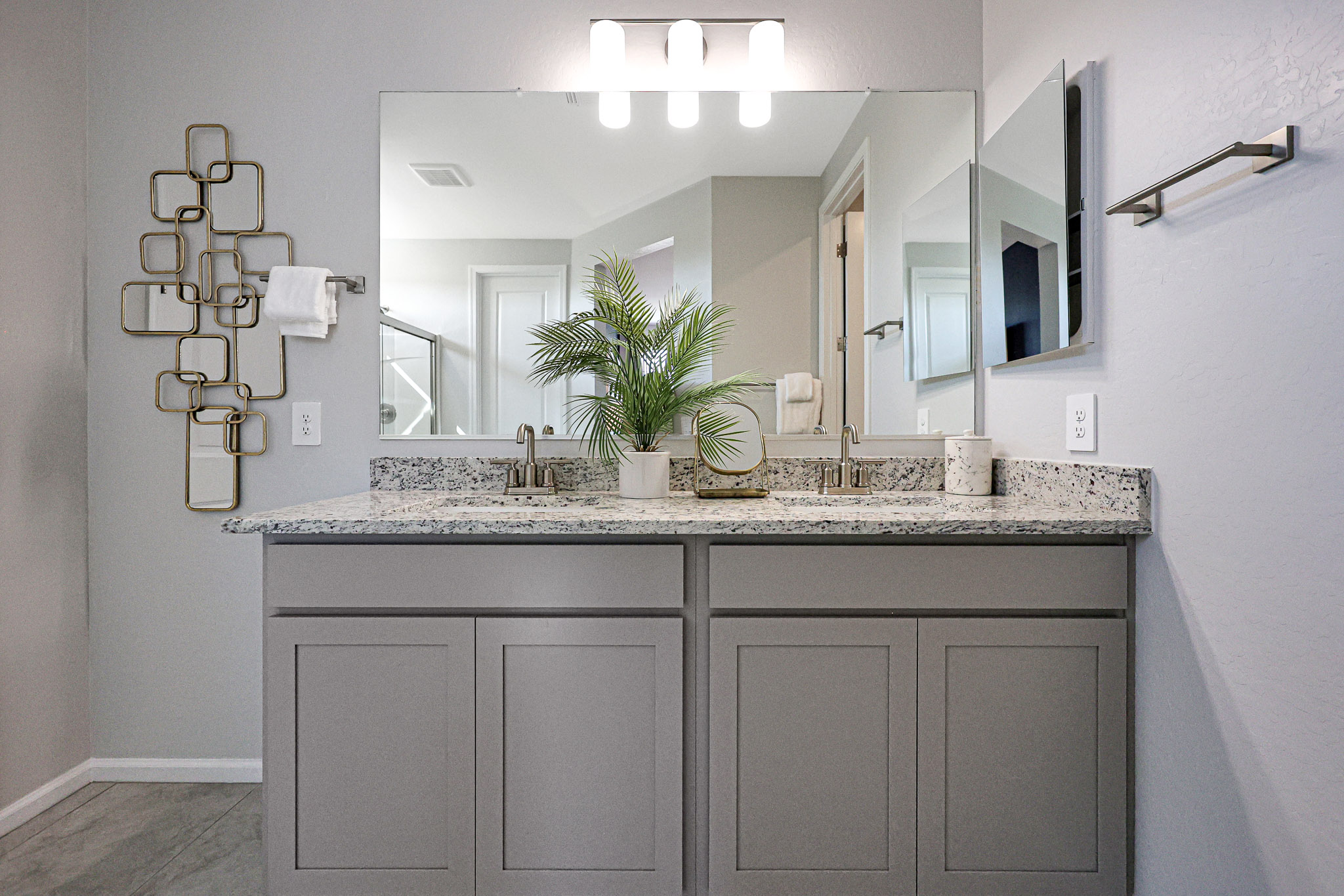 A bathroom with a large mirror.