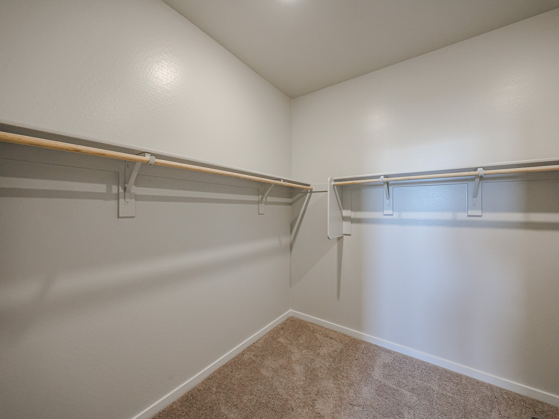 A white room with a metal railing.