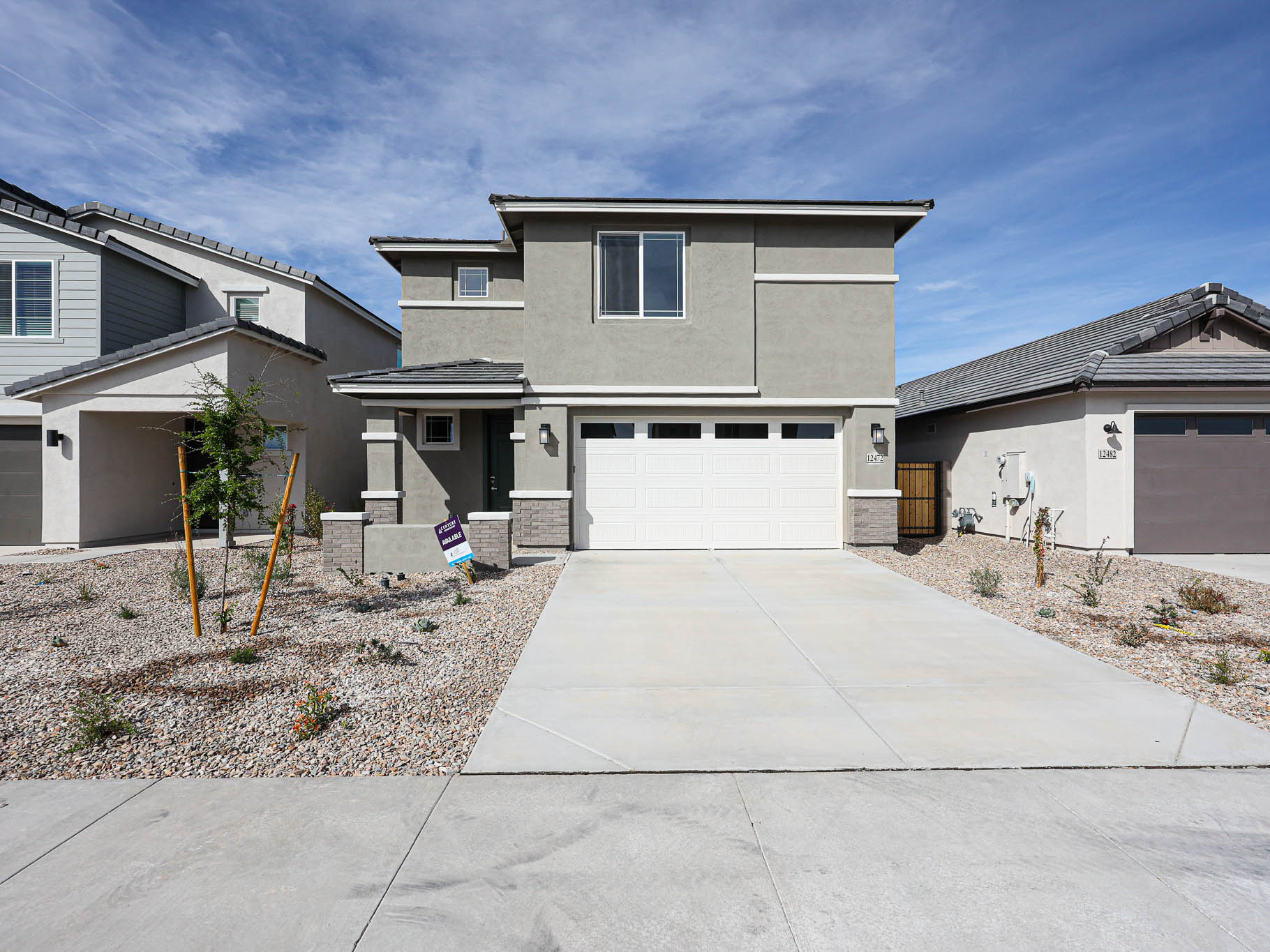 A driveway with a house in the background.