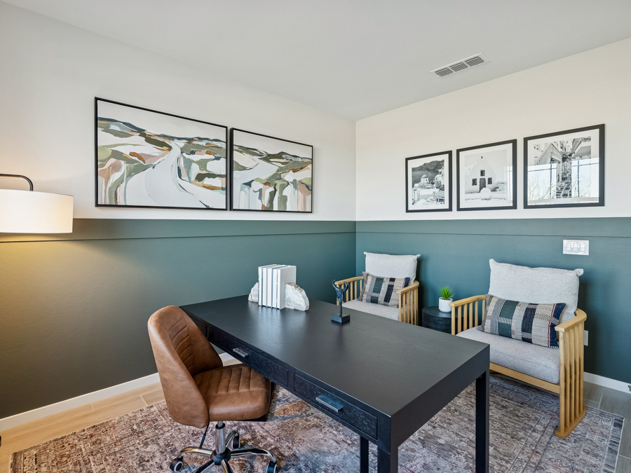 A living room with a table and chairs.