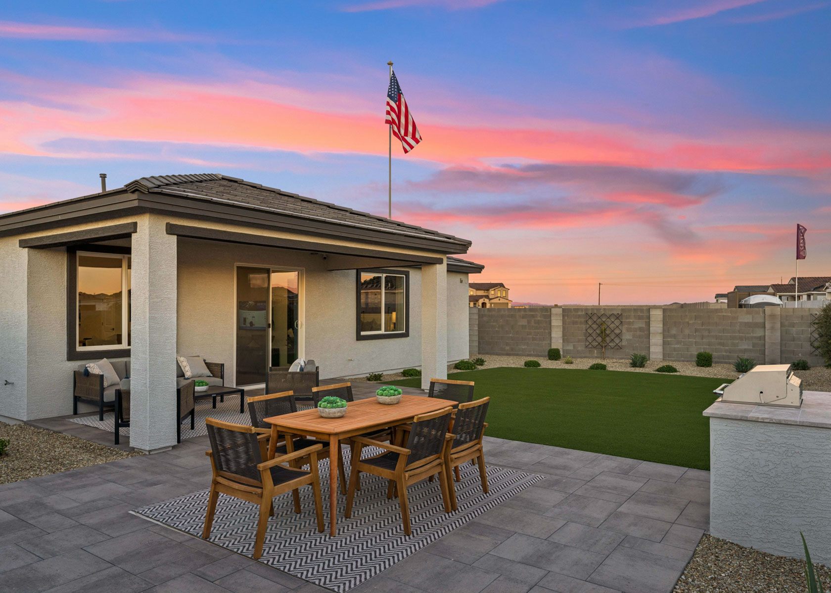 A patio with a table and chairs and a flag on it.