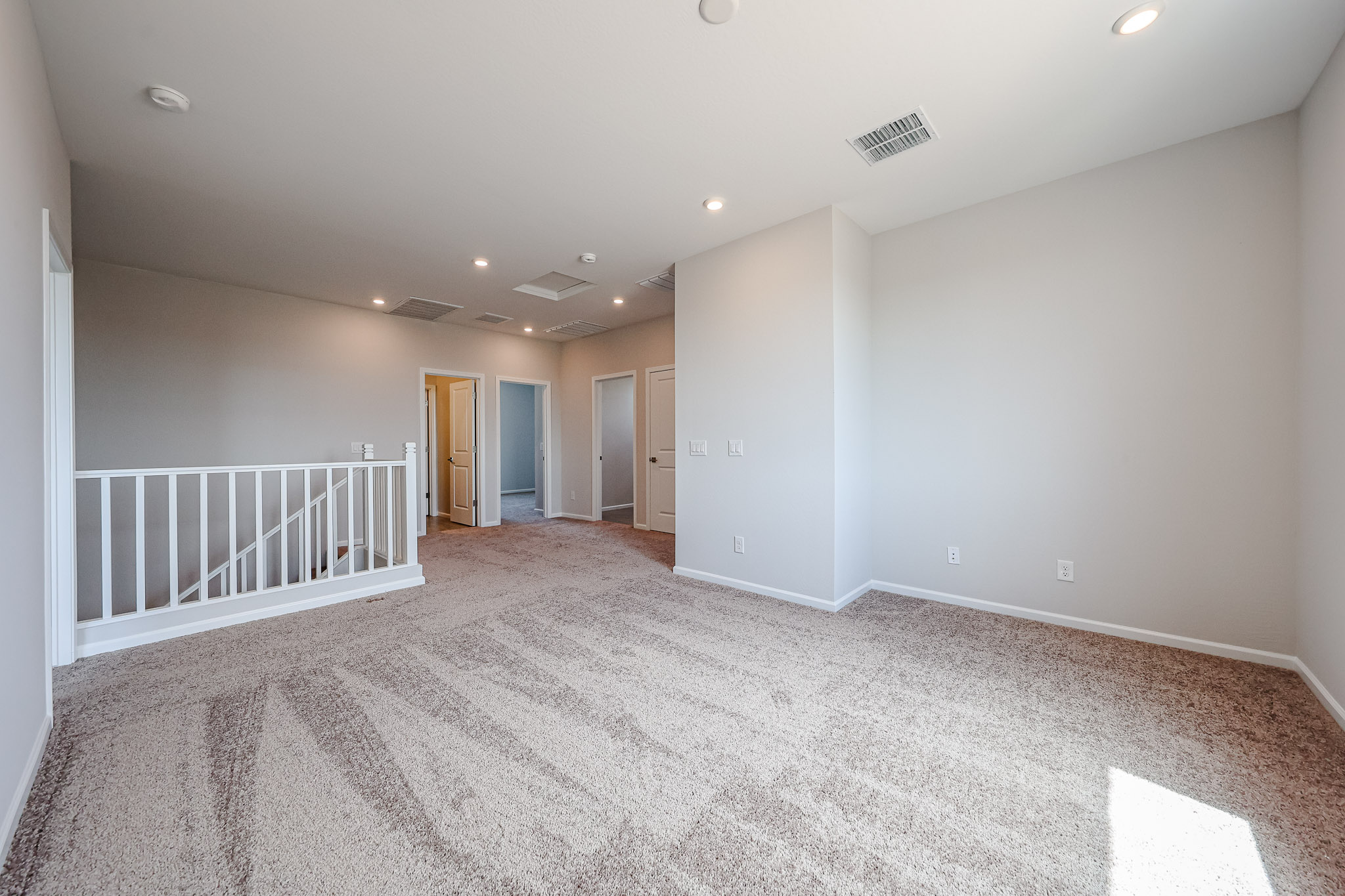 A long hallway with white walls.