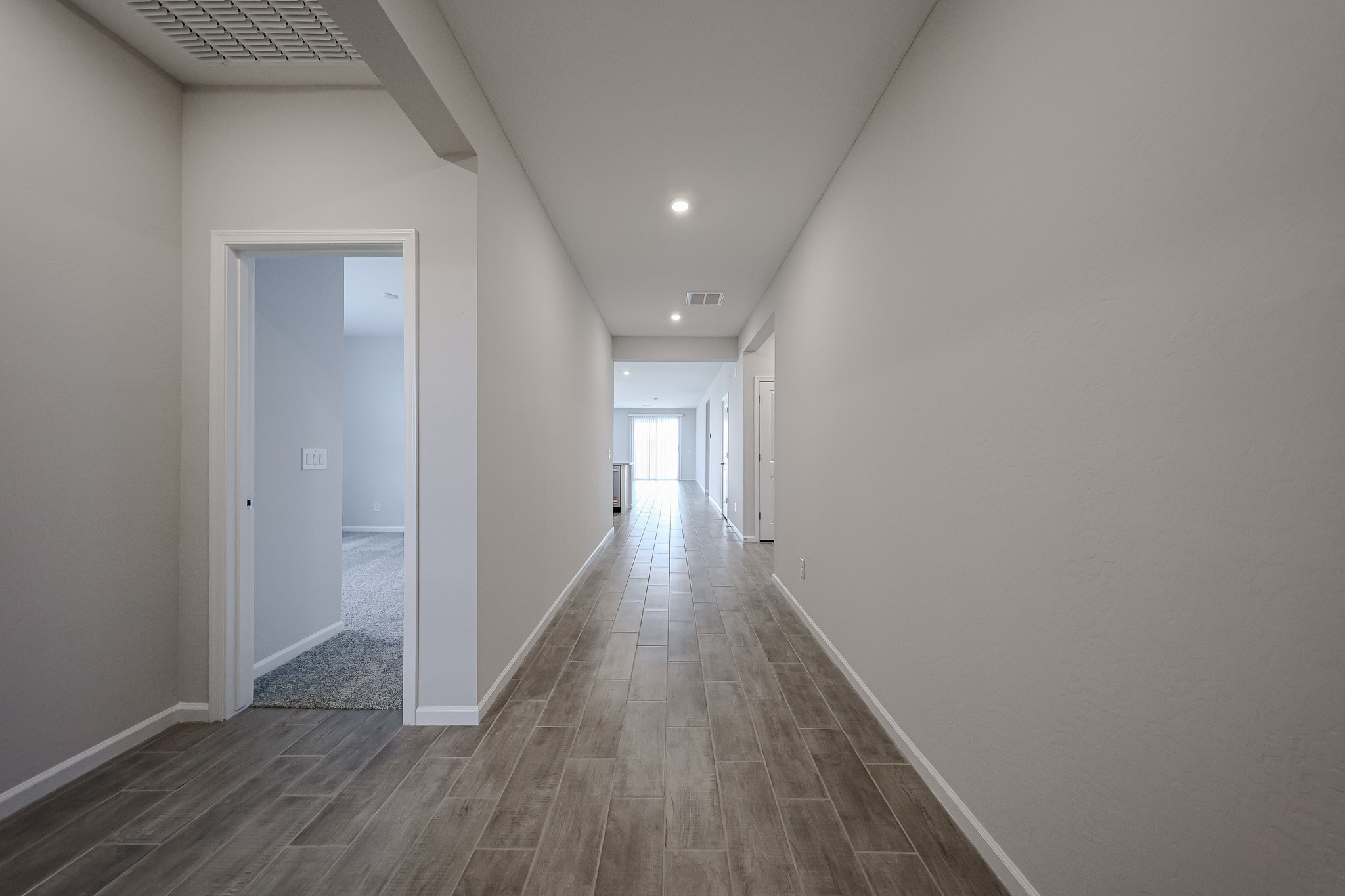A long hallway with white walls.