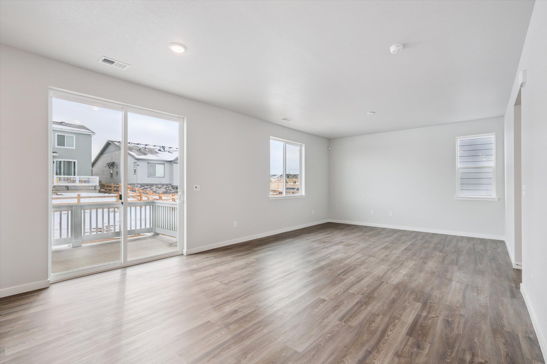 A room with a wood floor and a glass door.