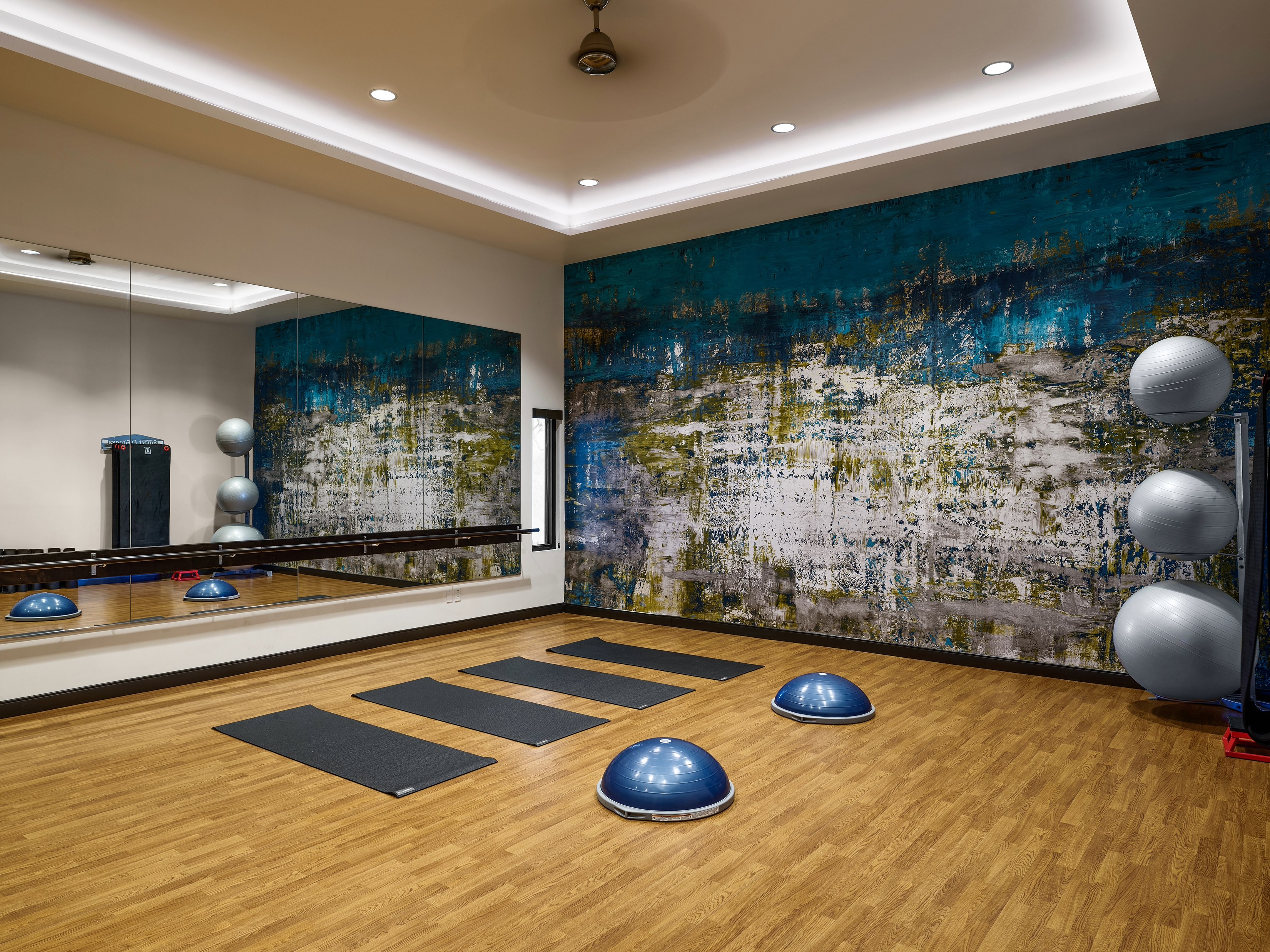 A room with a large wall of art.