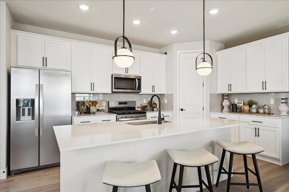 A kitchen with white cabinets.