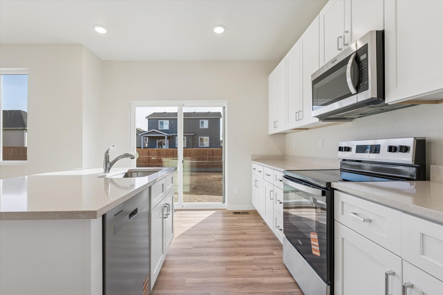 A kitchen with white cabinets.