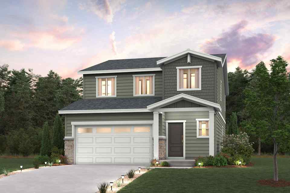 A house with a garage and trees in the back.