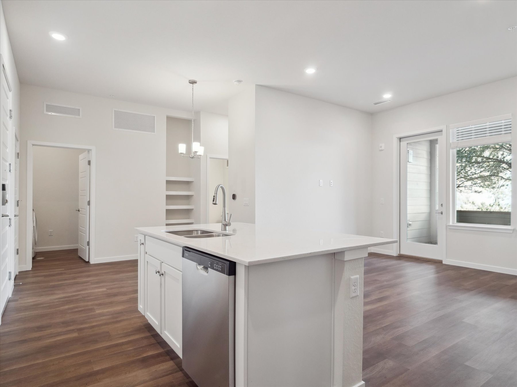 A kitchen with white cabinets.