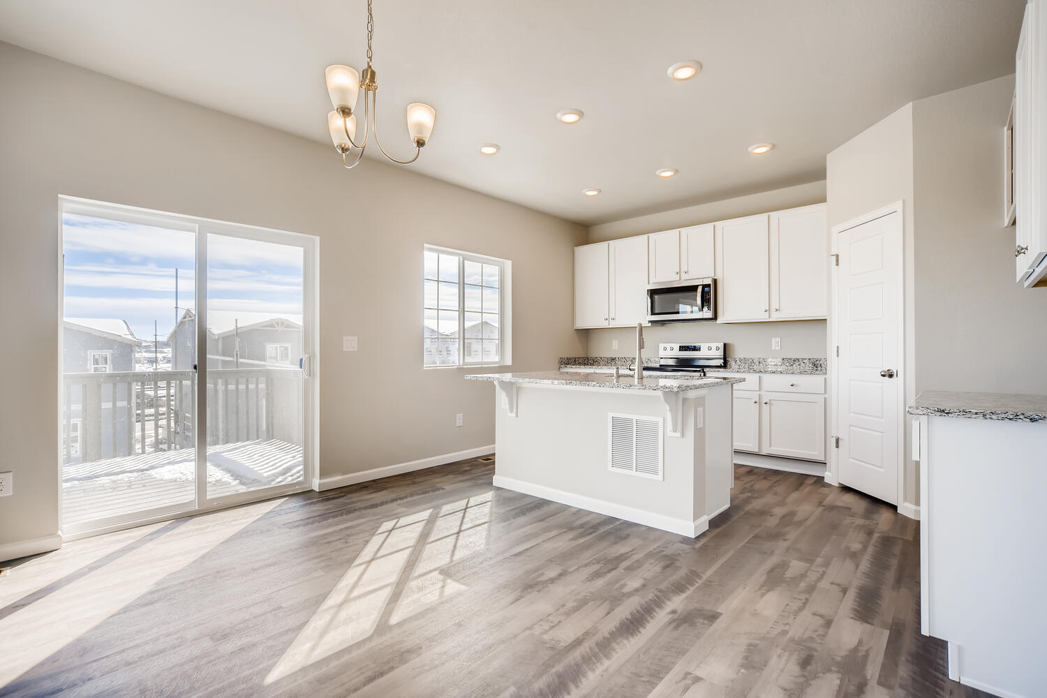 A kitchen with white cabinets.