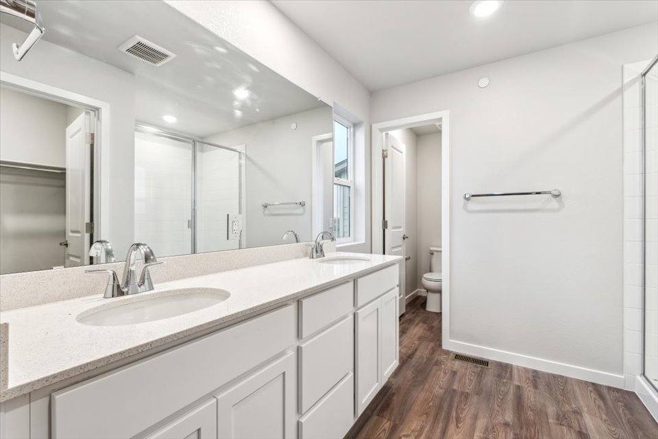 A bathroom with a large mirror.