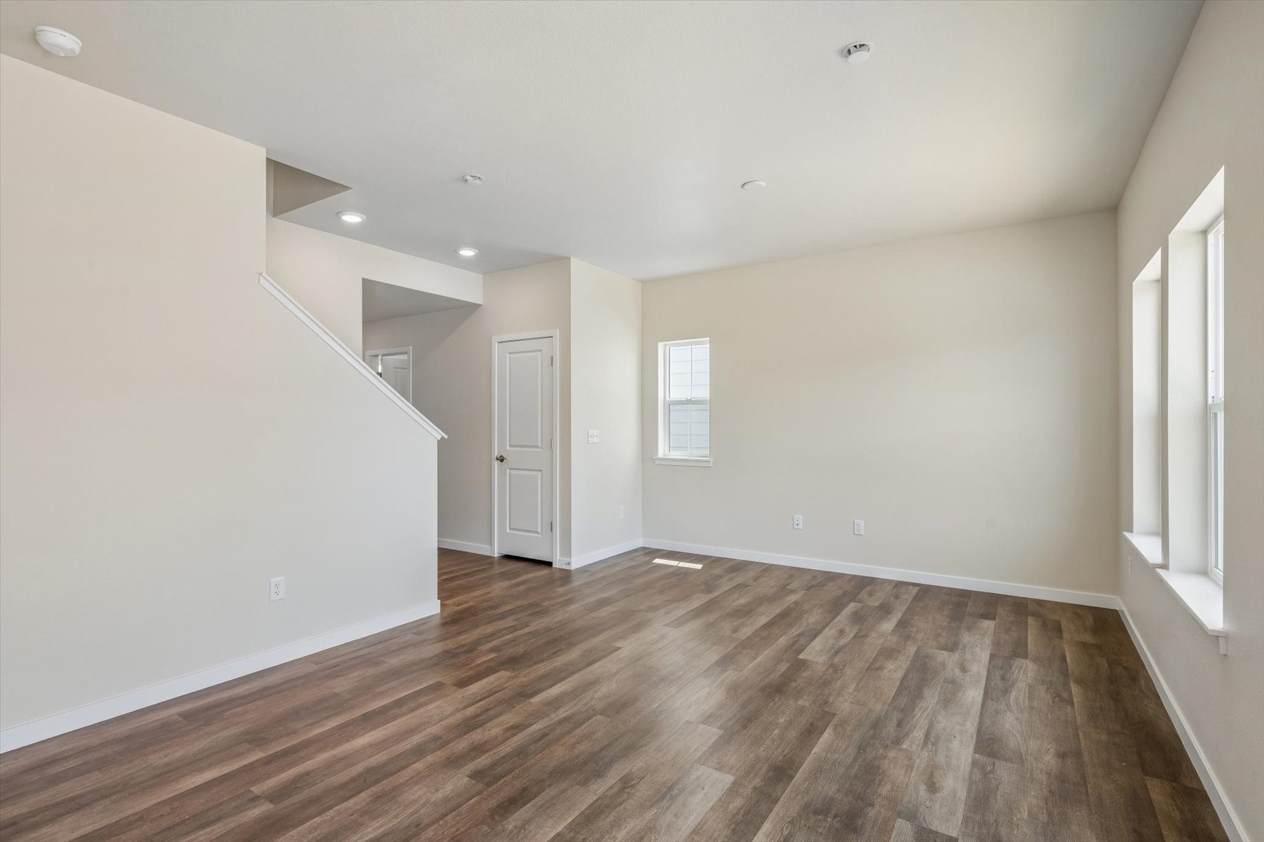 A room with a wood floor and white walls.