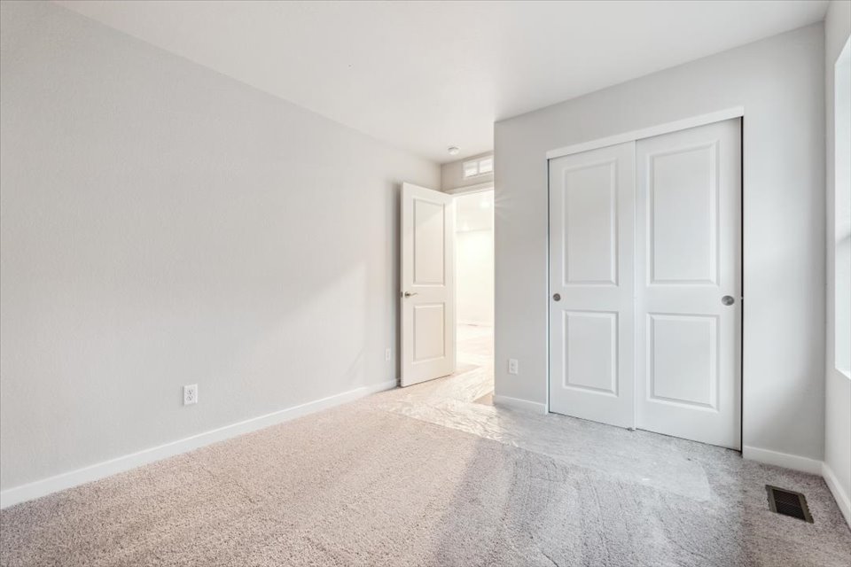 A hallway with white doors.