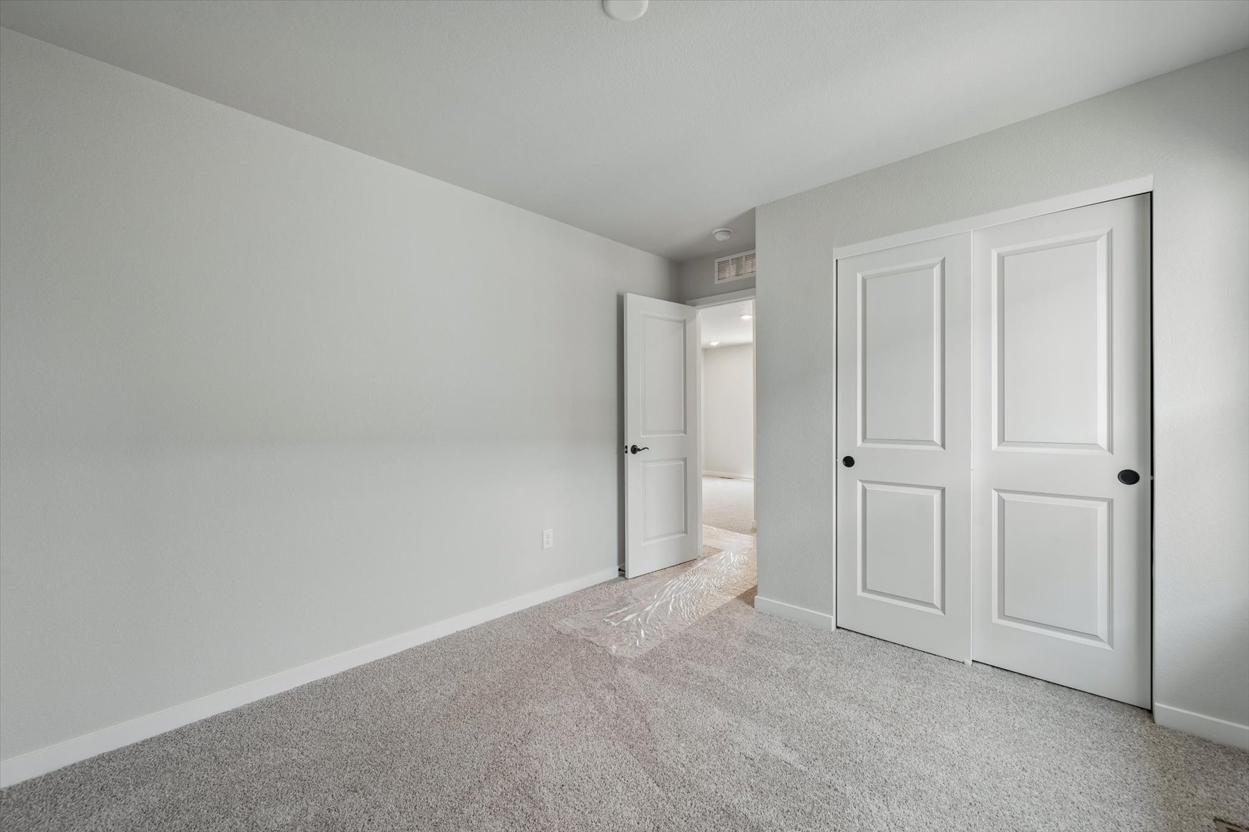 A hallway with white doors.