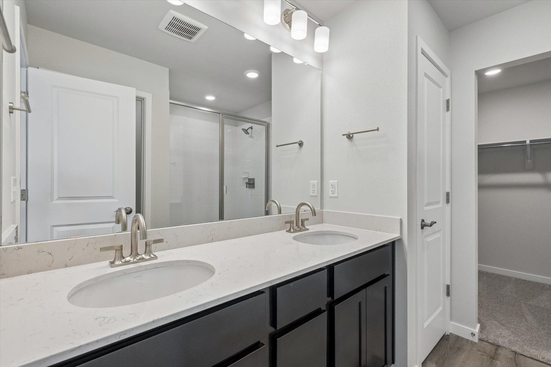 A bathroom with a large mirror.