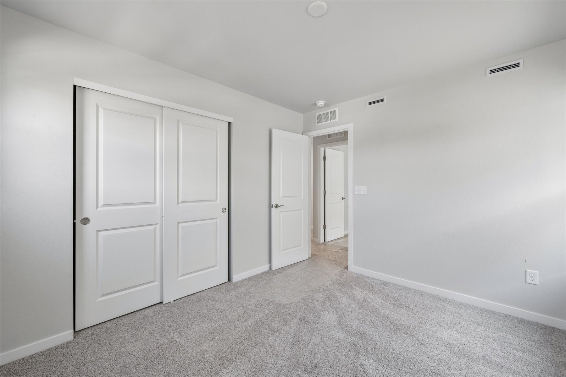A hallway with white doors.