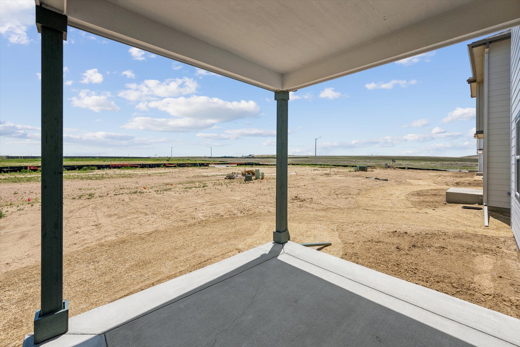 A view of a field from a window of a building.