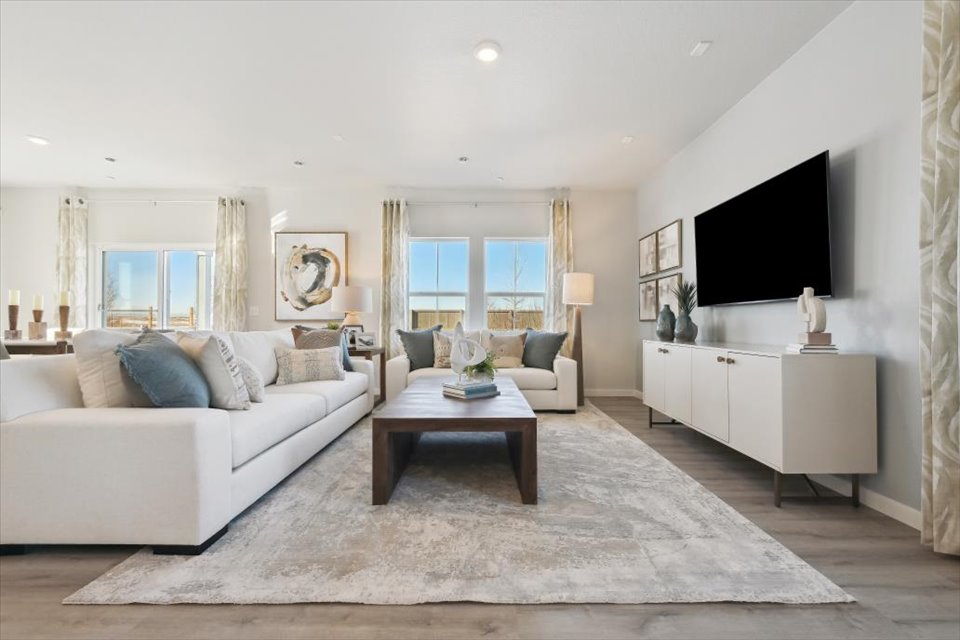 A living room with a large tv and a couch.