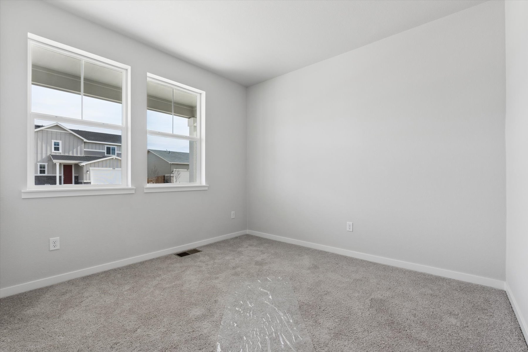 A room with a window and a carpet.