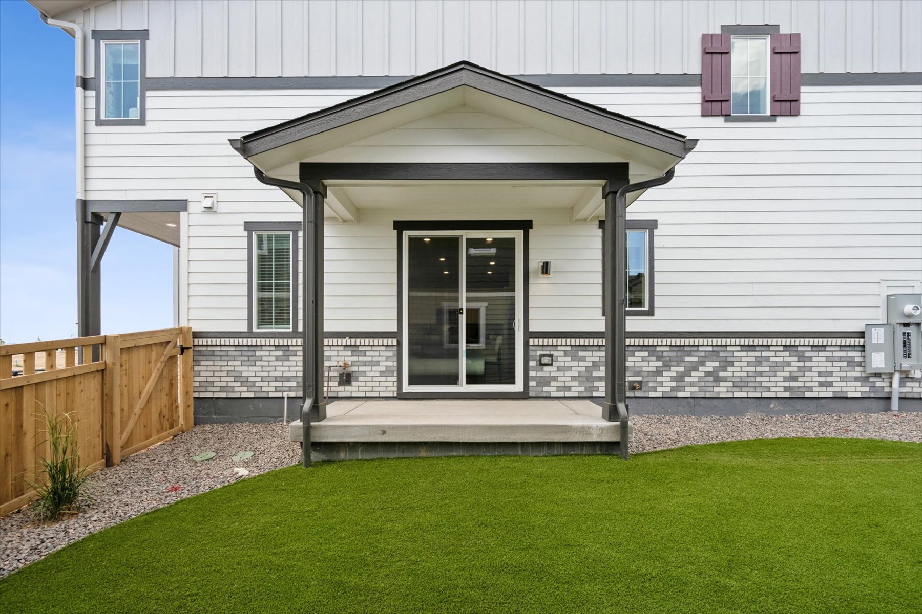 A house with a fence and grass.