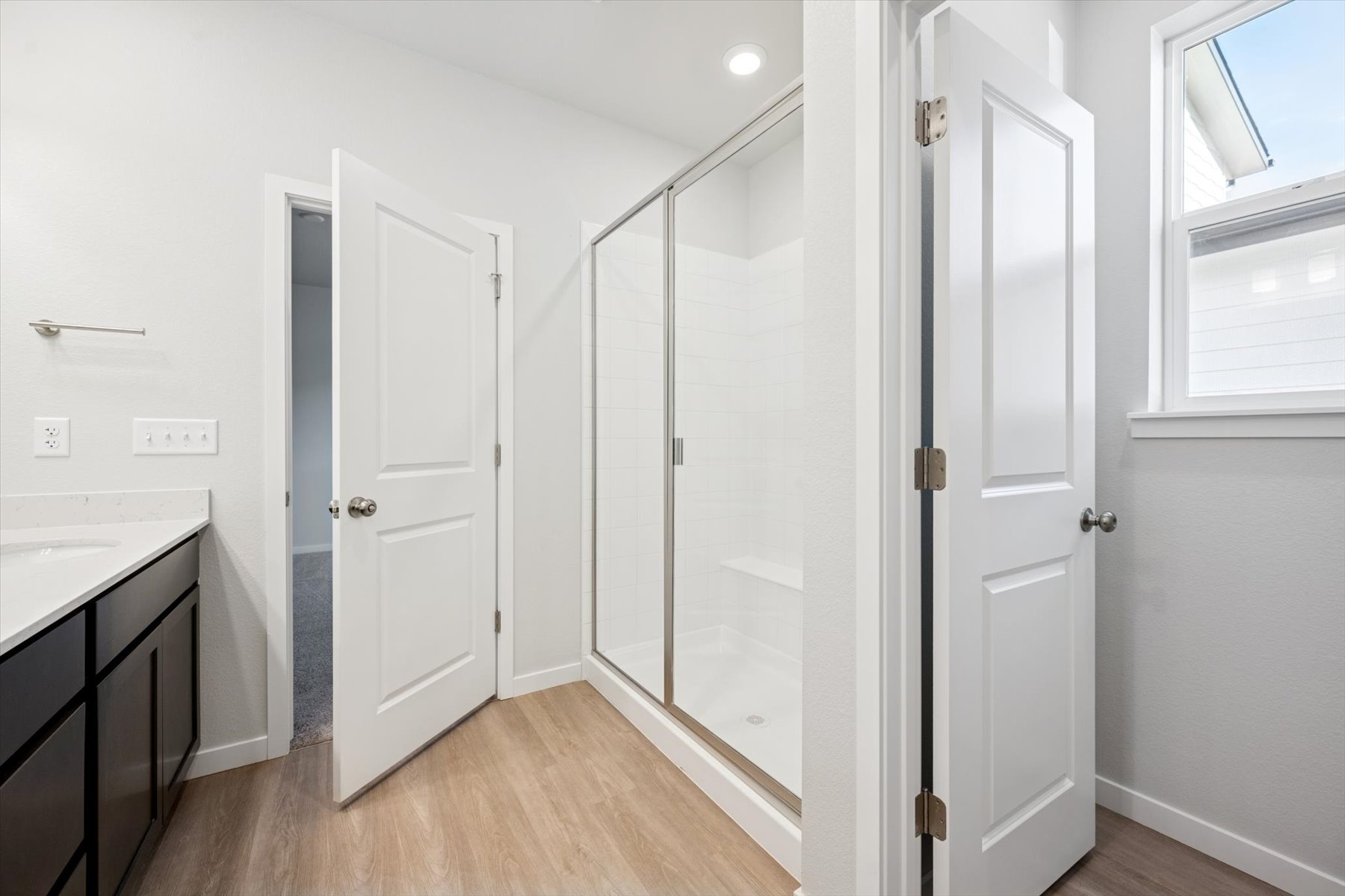 A room with a glass shower.