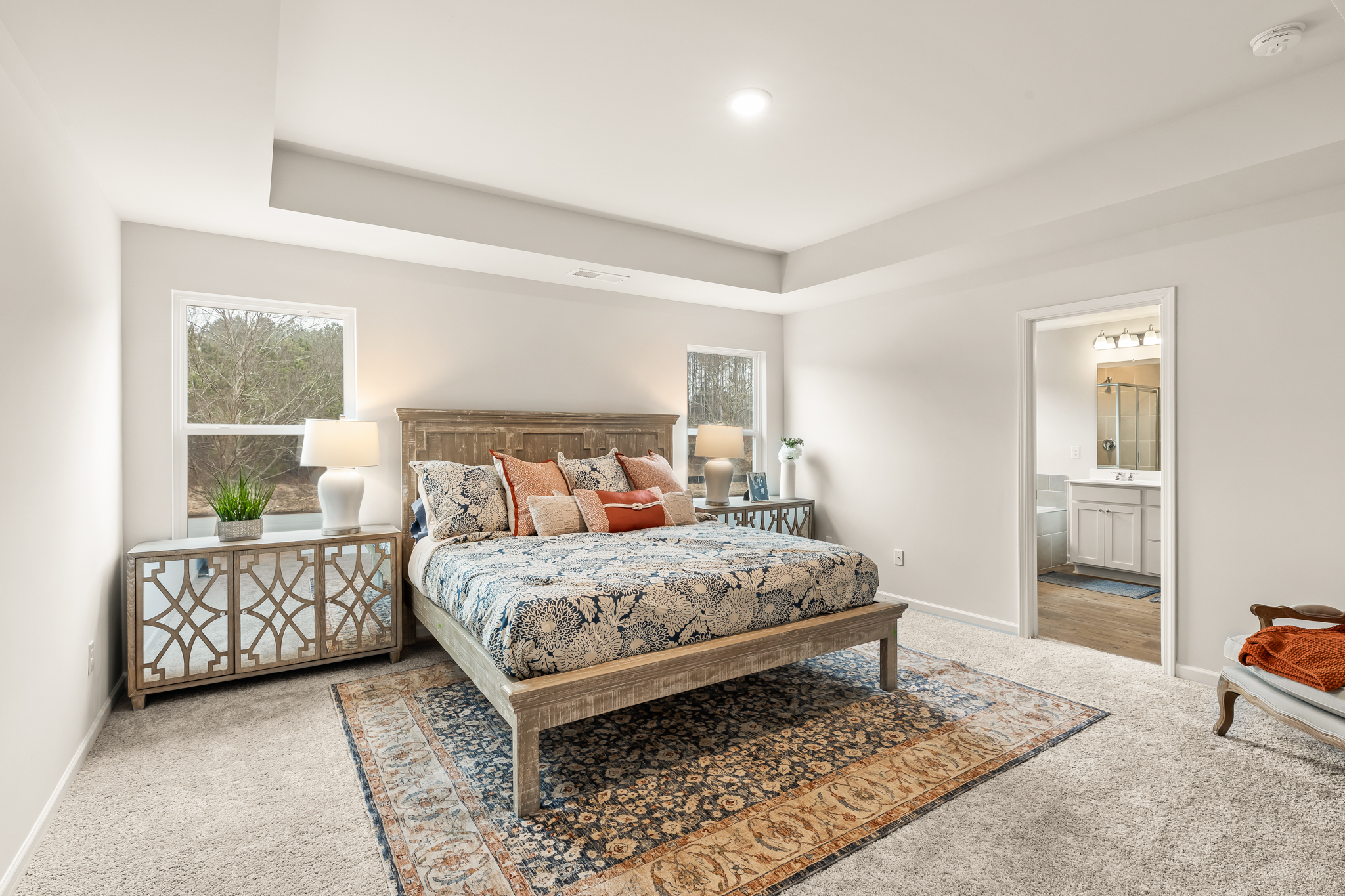 A bedroom with a bed and a table.