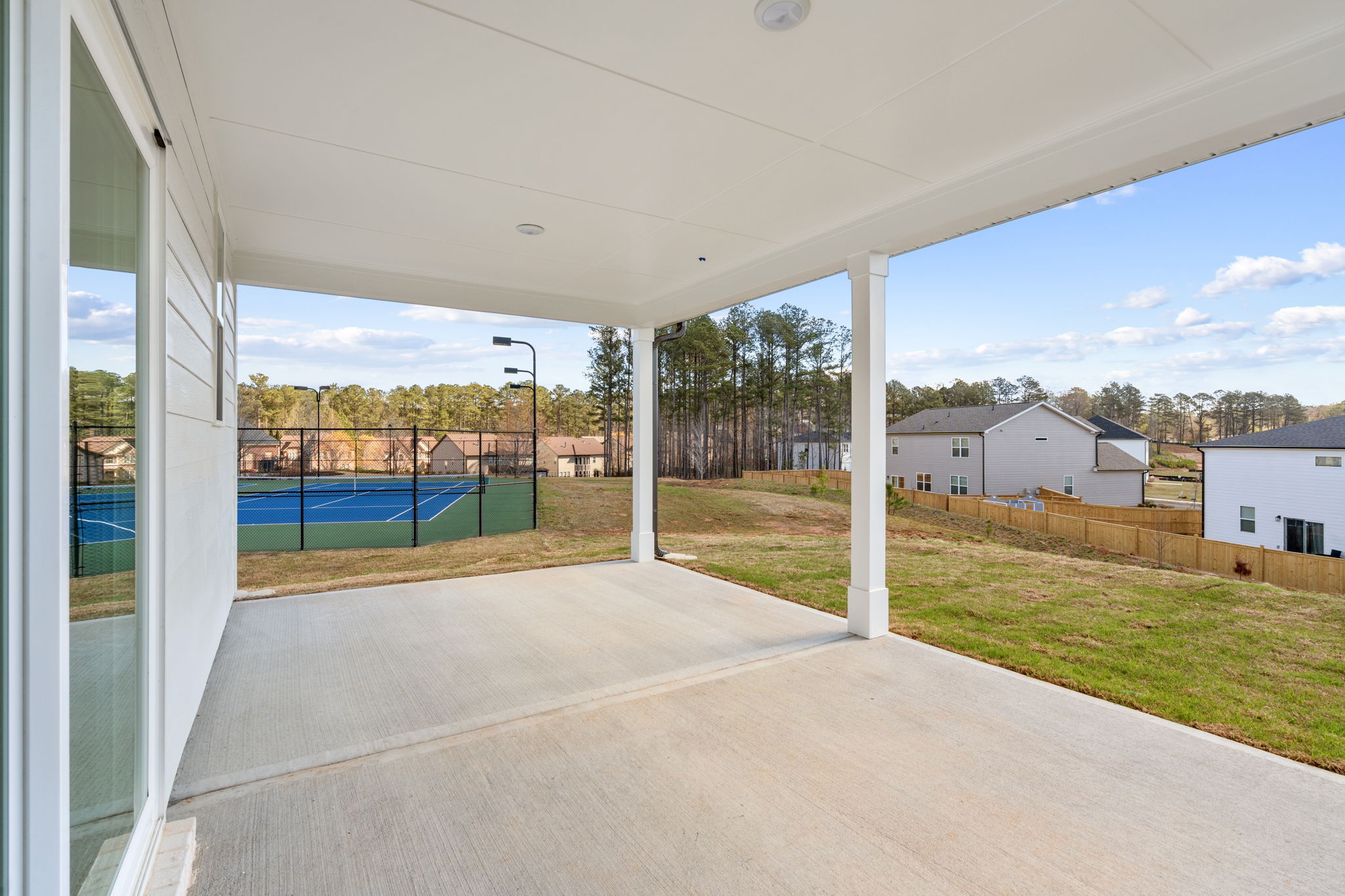 A walkway with grass and trees.