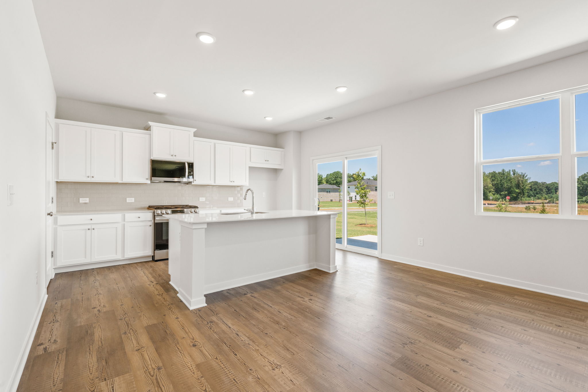A kitchen with white cabinets.