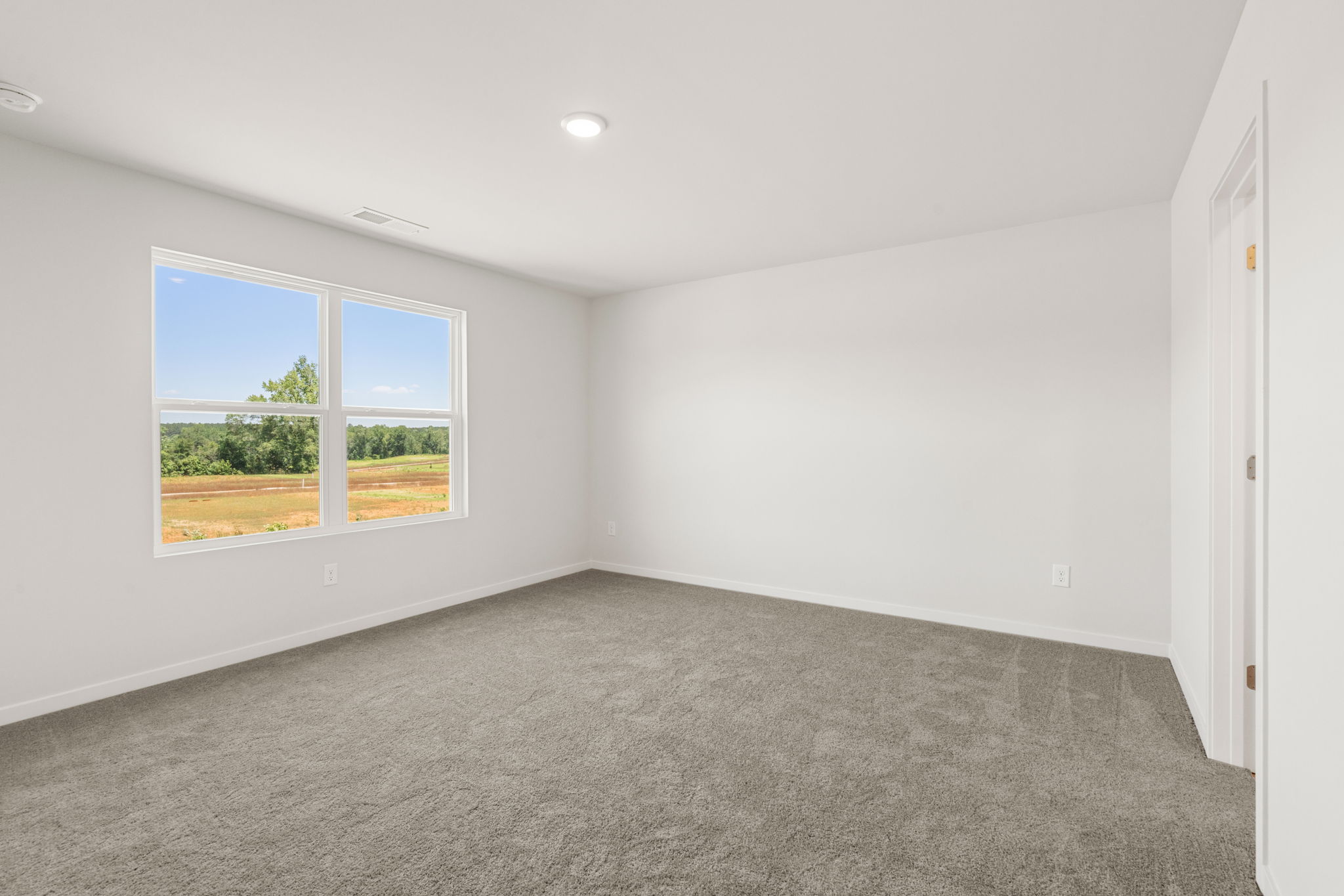 A room with a window and a door.